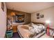 Comfortable bedroom with a cozy bed, wood-paneled wall, and a quirky design for a distinctive aesthetic at 4539 Peardale Dr, Las Vegas, NV 89147