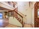 Elegant foyer with staircase featuring wood railing and tile flooring that leads into an adjacent dining area at 4539 Peardale Dr, Las Vegas, NV 89147