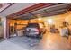 View of a garage featuring a parked car, storage shelves, a laundry area, and an open garage door at 4539 Peardale Dr, Las Vegas, NV 89147