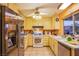 Well-lit kitchen boasts stainless steel appliances, tile countertops, and ample cabinet space for storage at 4539 Peardale Dr, Las Vegas, NV 89147