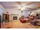 Cozy living room features a white brick fireplace, plush seating, and a ceiling fan for added comfort at 4539 Peardale Dr, Las Vegas, NV 89147
