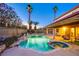 Inviting backyard pool and spa surrounded by lush landscaping and palm trees at 4539 Peardale Dr, Las Vegas, NV 89147