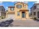 Two-story home featuring a two car garage, shutters, landscaping, and a brick paved driveway at 5324 Pendergrass St, North Las Vegas, NV 89081