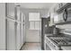 Kitchen with tiled floors, white cabinets, black hardware, and stainless steel appliances at 5324 Pendergrass St, North Las Vegas, NV 89081