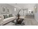 Staged living room featuring an open floor plan, neutral color palette, and tiled floors at 5324 Pendergrass St, North Las Vegas, NV 89081