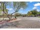 Street view of neighborhood with a paved brick road and mature trees at 5324 Pendergrass St, North Las Vegas, NV 89081