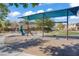 Exterior shot of neighborhood playground with swings, slides, and covered picnic area at 5324 Pendergrass St, North Las Vegas, NV 89081