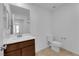 Bright bathroom with wood vanity, white countertop, and toilet at 5677 Asyma Ct, Las Vegas, NV 89113