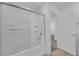 Bright bathroom with a shower-tub combination, white fixtures, and tile flooring at 5677 Asyma Ct, Las Vegas, NV 89113
