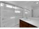 A white shower/tub combo offers a sliding glass door and chrome fixtures at 5677 Asyma Ct, Las Vegas, NV 89113