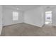 A bright bedroom offers carpeted floors and a view of the neighborhood at 5677 Asyma Ct, Las Vegas, NV 89113