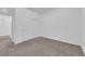 A cozy bedroom with neutral carpet, closet doors, and neutral walls at 5677 Asyma Ct, Las Vegas, NV 89113