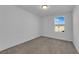 Neutral bedroom with carpet and a window showcasing the community at 5677 Asyma Ct, Las Vegas, NV 89113