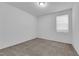 A cozy bedroom with neutral carpet, a window, and neutral walls at 5677 Asyma Ct, Las Vegas, NV 89113