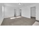 A neutral bedroom offers carpeted floors and ensuite bathroom and closet access at 5677 Asyma Ct, Las Vegas, NV 89113