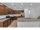 Charming kitchen featuring stainless steel appliances, granite counters, and brown wood cabinetry at 5677 Asyma Ct, Las Vegas, NV 89113