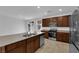 Kitchen featuring a stainless steel appliance package, granite countertops, and brown cabinetry at 5677 Asyma Ct, Las Vegas, NV 89113