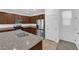 Charming kitchen featuring stainless steel appliances, granite counters, and brown wood cabinetry at 5677 Asyma Ct, Las Vegas, NV 89113