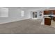 Open-concept living area with carpet and stainless steel appliances in kitchen at 5677 Asyma Ct, Las Vegas, NV 89113