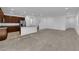 Spacious open concept featuring carpeted living area and stainless steel appliances in kitchen at 5677 Asyma Ct, Las Vegas, NV 89113