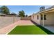 Open backyard showcasing turf, rock landscaping and a block wall at 5742 Forsythe Dr, Las Vegas, NV 89142