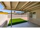 Covered patio with a view of the backyard with stone landscaping and turf at 5742 Forsythe Dr, Las Vegas, NV 89142