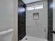 Updated modern bathroom with a large walk in shower with black and white tile at 5742 Forsythe Dr, Las Vegas, NV 89142