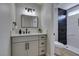 Modern bathroom featuring a sleek vanity, a contemporary mirror, and a tiled shower with a glass door at 5742 Forsythe Dr, Las Vegas, NV 89142