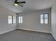 Spacious bedroom with plush carpet, three windows, and neutral colored walls at 5742 Forsythe Dr, Las Vegas, NV 89142