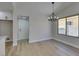 Dining area with modern light fixture and wood-look floors, adjacent to the kitchen at 5742 Forsythe Dr, Las Vegas, NV 89142