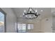 Bright dining room with modern chandelier, ceiling fan, and sliding glass doors to the backyard at 5742 Forsythe Dr, Las Vegas, NV 89142