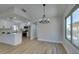 Dining area open to kitchen, featuring modern light fixture and wood-look floors at 5742 Forsythe Dr, Las Vegas, NV 89142