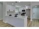 Modern kitchen featuring white cabinets, quartz countertops, and stainless steel appliances at 5742 Forsythe Dr, Las Vegas, NV 89142