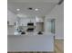 Bright kitchen features white cabinetry, stainless steel appliances, and a large island with a white countertop at 5742 Forsythe Dr, Las Vegas, NV 89142