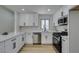 Modern kitchen showcasing sleek white cabinetry, stainless steel appliances, and a stylish countertop at 5742 Forsythe Dr, Las Vegas, NV 89142
