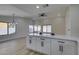 Updated kitchen featuring white cabinets and quartz countertops flowing into the dining area at 5742 Forsythe Dr, Las Vegas, NV 89142