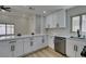 Bright modern kitchen with white cabinets, quartz countertops, and stainless steel appliances at 5742 Forsythe Dr, Las Vegas, NV 89142