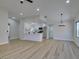 Open-concept living space with modern chandelier and views of the updated kitchen with breakfast bar at 5742 Forsythe Dr, Las Vegas, NV 89142