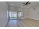 Light-filled living room featuring wood-look floors, recessed lighting, and a large sliding glass door to the backyard at 5742 Forsythe Dr, Las Vegas, NV 89142
