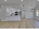 Bright living area featuring wood-look floors, modern lighting, and open access to kitchen at 5742 Forsythe Dr, Las Vegas, NV 89142