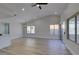 Bright and spacious living room featuring high ceilings, slider door and wood-look flooring at 5742 Forsythe Dr, Las Vegas, NV 89142