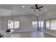 Bright living room showcasing a vaulted ceiling, wood-look floors, and ample natural light from multiple windows at 5742 Forsythe Dr, Las Vegas, NV 89142