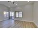 Spacious living room boasts wood-look floors, recessed lighting, and large windows providing ample natural light at 5742 Forsythe Dr, Las Vegas, NV 89142