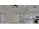 Bright, open-concept living room and kitchen area featuring sleek white cabinets and modern appliances at 5742 Forsythe Dr, Las Vegas, NV 89142