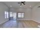 Well-lit living room featuring wood-look floors, recessed lighting, and access to the outdoors through sliding glass doors at 5742 Forsythe Dr, Las Vegas, NV 89142
