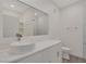 Modern bathroom with a vessel sink, countertop, and large mirror at 5751 E Hacienda Ave # 159, Las Vegas, NV 89122