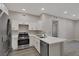 Well-lit kitchen with stainless steel appliances, a breakfast bar and white cabinetry at 5751 E Hacienda Ave # 159, Las Vegas, NV 89122