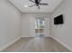 Inviting living room with sliding glass doors, ceiling fan, and a mounted television at 5751 E Hacienda Ave # 159, Las Vegas, NV 89122