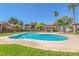 Community pool featuring lounge chairs, nearby landscaping and mature trees at 5751 E Hacienda Ave # 159, Las Vegas, NV 89122