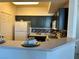 Contemporary kitchen with dark cabinetry, a breakfast bar, and stylish decor at 5855 Valley Dr # 2092, North Las Vegas, NV 89031
